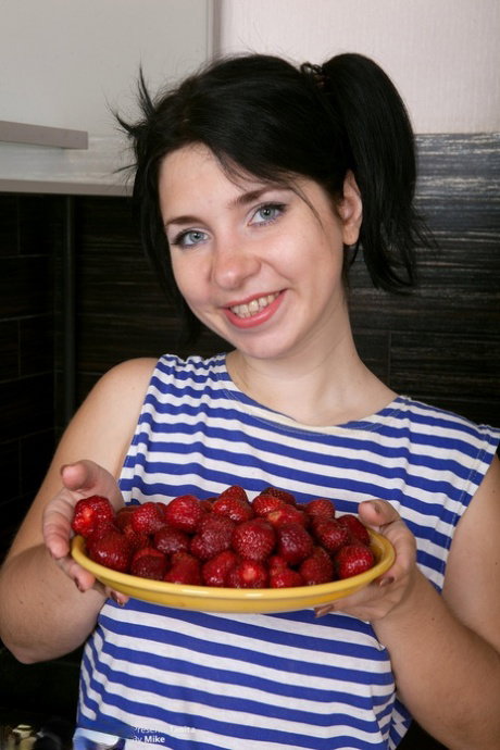 Raven haired blue eyed babe Tanita undresses and plays with her bush twat