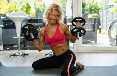 Older blonde Liliana Gold works out in a gym before sex on a yoga mat
