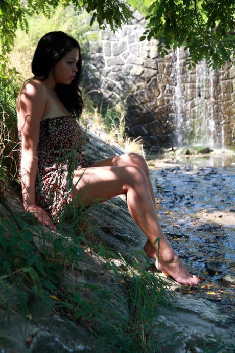 Big titted Latina girl Katarina takes off her dress to go nude on a riverbank