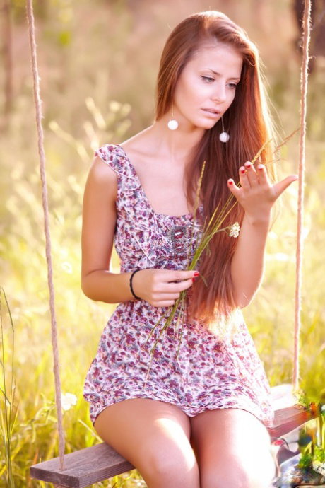 Cute redhead teen Jasmine D poses in a sexy dress and while naked outdoors