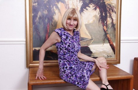 Older lady Bossy Ryder revealing large boobs before tugging on labia lios