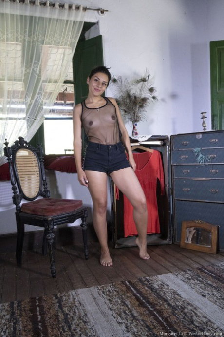 Amateur sweetie Margaret Li flaunts her hairy muff and small tits in a solo