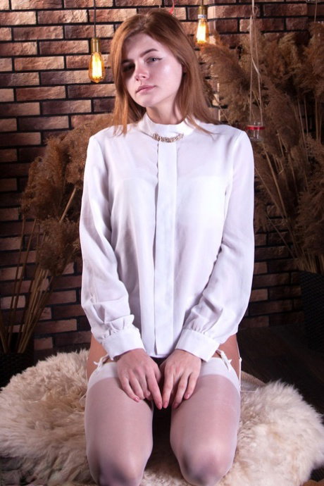 Young looking redhead Persik completely exposes her slender figure