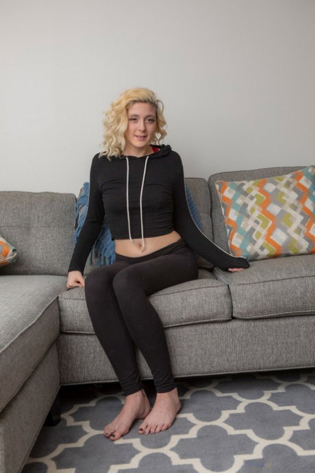 Amateur with curly blond hair Sydney Moon touts her nice ass in her nude debut