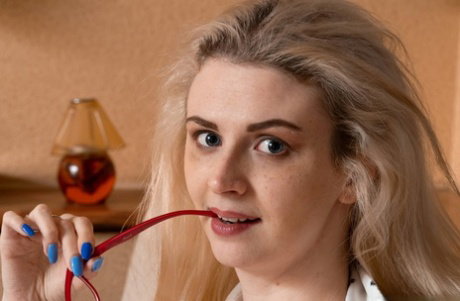 Blonde amateur Linda Maers does some reading after fingering her bush