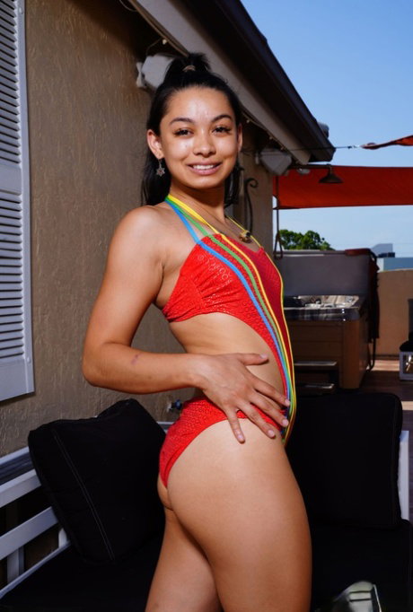 Asian teen Iris Ivy removes red swimwear while going nude on a patio