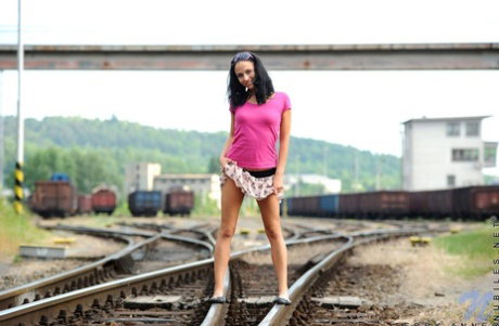 Dark-haired teen Terry Anne exposes herself in a railway yard