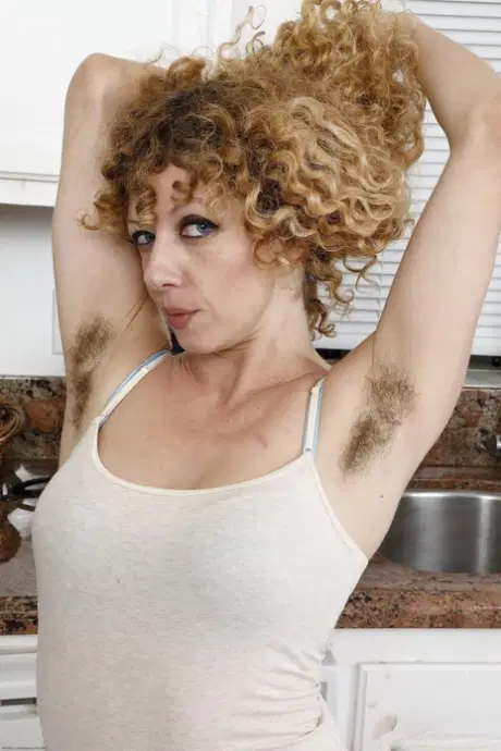 Curly-haired amateur Leona unveils her big ass and plays with her hairy pussy