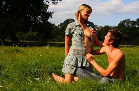 Blonde teen and her boyfriend have sex in the middle of a field