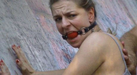 Big titted blonde has her asshole penetrated while restrained in public
