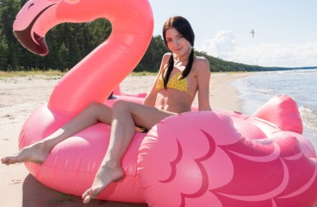 Cute teen Velvet finger fucks on an an inflatable craft in pigtails