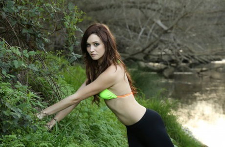 Natural redhead Hayden Ryan poses non nude in swimwear by a river