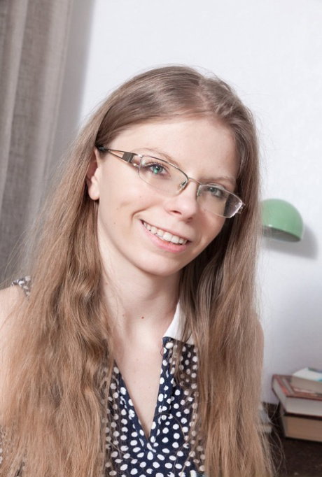 Glasses clad Ekaterina Ananasova bares her nice tits & fingers her hairy muff