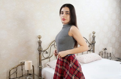 Young brunette Regina Mua disrobes before masturbating with a dildo