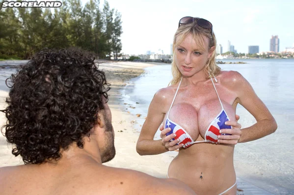 Older blonde Morgan Leigh tugs on a dick after loosing fake tits from a bikini  - Fake Tits, Beach, Mature, Big Tits, Bikini, MILF, Outdoor, Oiled, Blonde, Glasses  - Photo 10