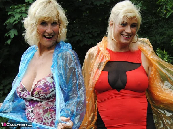 Mature lesbian Dimonty and GF cover their naked bodies in see thru raincoats  - Mature, Latex, Outdoor, Lesbian, Clothed, Skirt, Blonde, Humping, MILF, European  - Photo 10