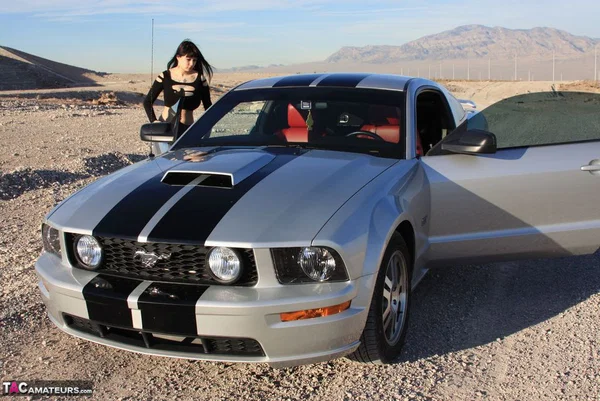 Brunette amateur Susy Rocks models by a muscle car during a safe for work gig  - Outdoor, Tall, Ass, Amateur, PAWG, Beautiful, Solo, Brunette, Non Nude  - Photo 1