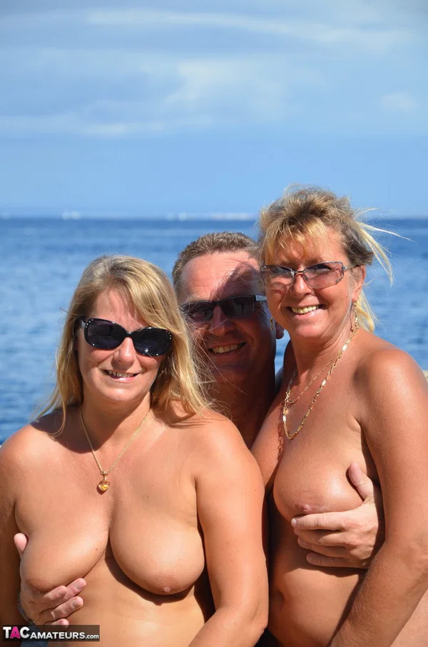 Two blonde women with saggy tits enjoy hot suck and fuck in beach threesome  - Beach, Mature, Reality, Outdoor, Amateur, MILF, European, Blowjob, Threesome, Blonde  - Photo 1