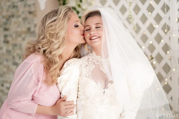 Carolina Sweets is affixed with a garter before a lesbian wedding to Julia Ann  - Wedding, Reality, Mature, Upskirt, Non Nude, MILF, Lesbian, Blonde, Skirt, Skinny  - Photo 7