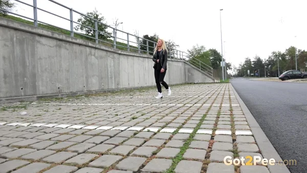 Blonde girl Jena Lovely pulls down black leggings for a pee near an overpass  - Pissing, Babe, Outdoor, Blonde, Leather, Clothed, Undressing, Beautiful, Solo  - Photo 1