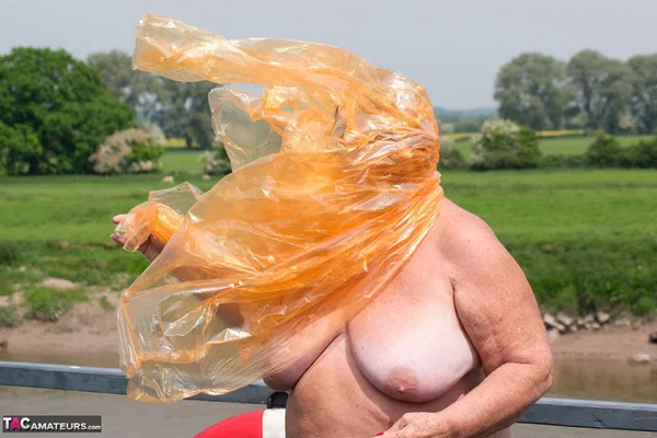 Obese oma Grandma Libby doffs a see-through raincoat to get naked on a bridge  - SSBBW, Granny, Saggy Tits, BBW, Chubby, Amateur, Curvy, Fetish, Thick, Glasses  - Photo 20