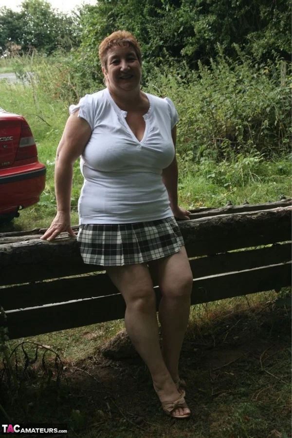 Fat British lady Kinky Carol unleashes her large breasts over a rustic fence  - Mature, Thick, BBW, Chubby, British, Outdoor, Upskirt, Saggy Tits, Curvy, Clothed  - Photo 1