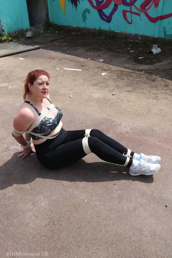 Redheaded girl Mada Rose is left on a paved lot while tied up  - Yoga Pants, Redhead, MILF, BDSM, Outdoor, Clothed, Bondage, Pigtails  - Photo 7