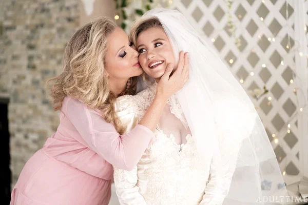 Carolina Sweets is affixed with a garter before a lesbian wedding to Julia Ann  - Wedding, Reality, Mature, Upskirt, Non Nude, MILF, Lesbian, Blonde, Skirt, Skinny  - Photo 8