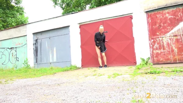 Blonde girl Nykla hitches up her dress before taking a piss by a garage  - Pissing, Pussy, Close Up, Panties, Shaved, Spreading, Outdoor, Skirt, Beautiful, Solo  - Photo 4