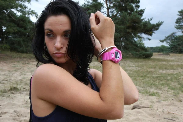 Brunette girl Nora is handcuffed to a tree while wearing a pink G-Shock watch  - Boots, Clothed, Beautiful, Outdoor, Leather, Skirt, Amateur, Solo, High Heels, Non Nude  - Photo 7