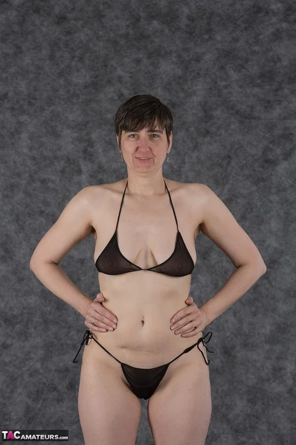 Short haired amateur holds her boobs after taking off a black bikini  - Saggy Tits, MILF, Short Hair, Bikini, Panties, Ass, Tiny Tits, Shaved, Legs, PAWG  - Photo 1