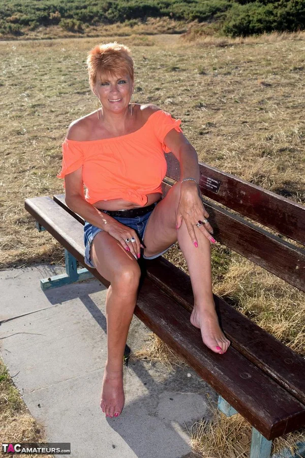 Older redhead Dimonty uncovers her natural tits not too far from the ocean  - Mature, Saggy Tits, Short Hair, Shorts, Redhead, Amateur, Glasses, Outdoor, Clothed, Legs  - Photo 6
