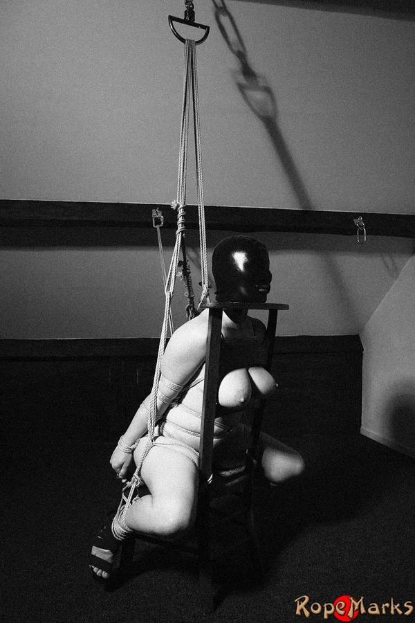 Hooded model Amely is tied and suspended by ropes in an attic setting  - Bondage, Blindfold, Latex, BDSM, Big Tits  - Photo 8