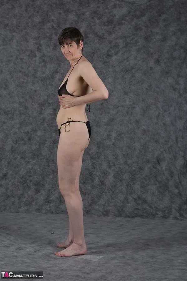 Short haired amateur holds her boobs after taking off a black bikini  - Saggy Tits, MILF, Short Hair, Bikini, Panties, Ass, Tiny Tits, Shaved, Legs, PAWG  - Photo 6