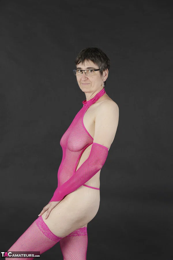 Mature amateur gets naked in pink arm socks and stockings with her glasses on  - Saggy Tits, Mature, Glasses, Short Hair, Lingerie, Amateur, Stockings, Brunette, European  - Photo 1