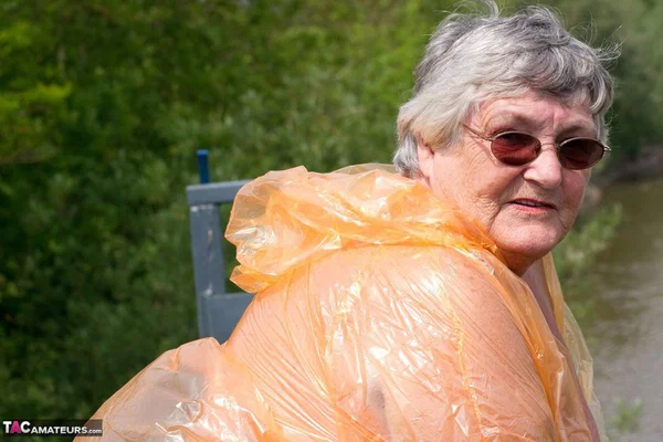 Obese oma Grandma Libby doffs a see-through raincoat to get naked on a bridge  - SSBBW, Granny, Saggy Tits, BBW, Chubby, Amateur, Curvy, Fetish, Thick, Glasses  - Photo 13