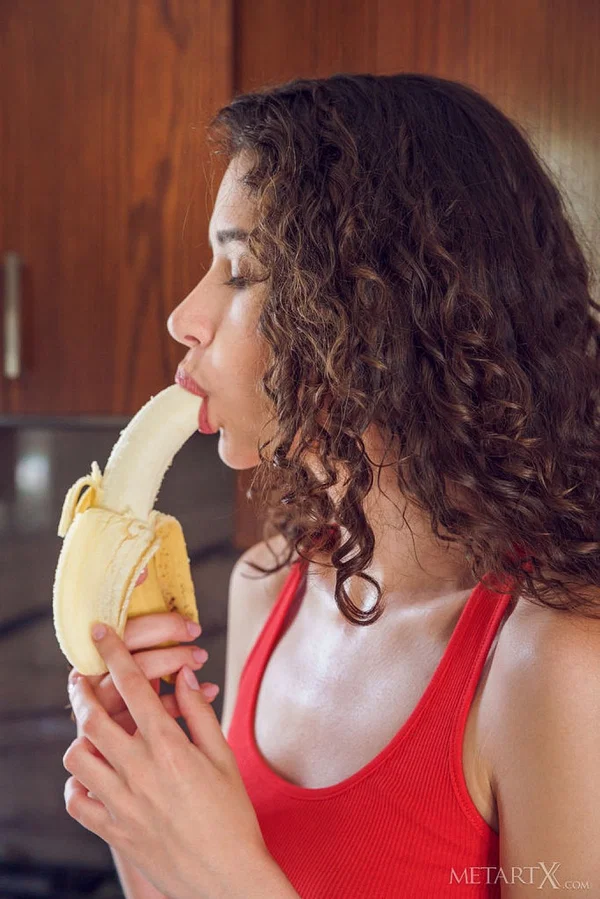 Young girl with wavy brunette hair Cristin gets naked after eating a banana  - Teen, Tiny Tits, Legs, Panties, Pussy, Close Up, Ass, Shaved, Spreading, PAWG  - Photo 1