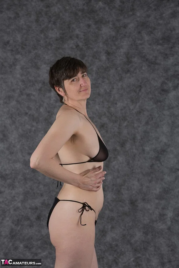 Short haired amateur holds her boobs after taking off a black bikini  - Saggy Tits, MILF, Short Hair, Bikini, Panties, Ass, Tiny Tits, Shaved, Legs, PAWG  - Photo 4