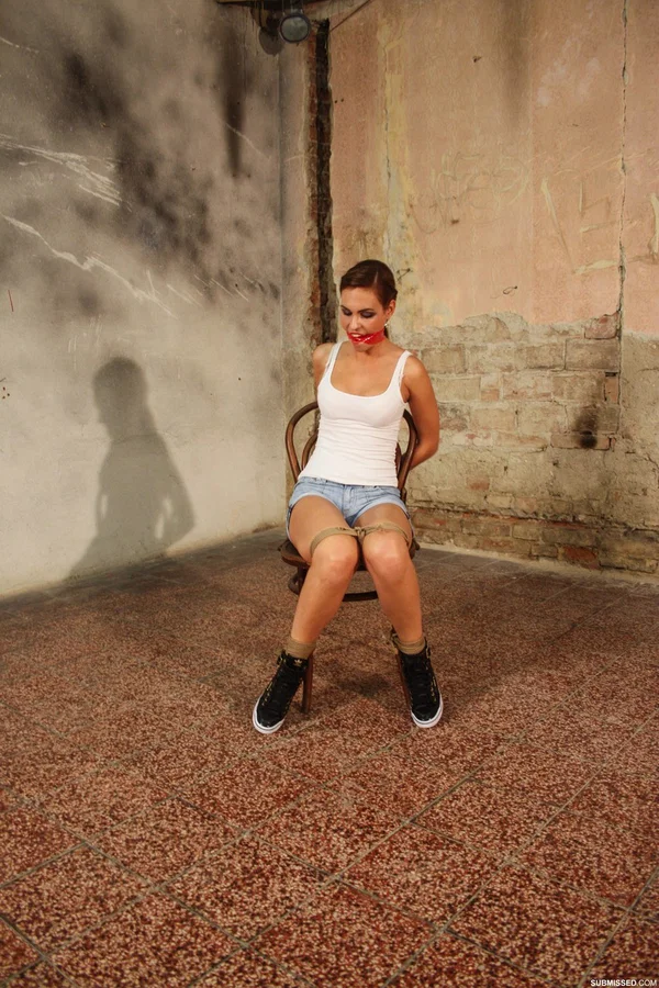 Gorgeous brunette poses tied to a chair in jean shorts and a white tank top  - Bondage, BDSM, Brunette  - Photo 12