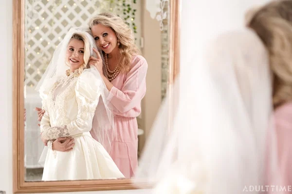 Carolina Sweets is affixed with a garter before a lesbian wedding to Julia Ann  - Wedding, Reality, Mature, Upskirt, Non Nude, MILF, Lesbian, Blonde, Skirt, Skinny  - Photo 14