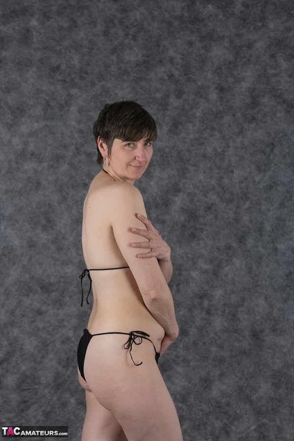 Short haired amateur holds her boobs after taking off a black bikini  - Saggy Tits, MILF, Short Hair, Bikini, Panties, Ass, Tiny Tits, Shaved, Legs, PAWG  - Photo 3