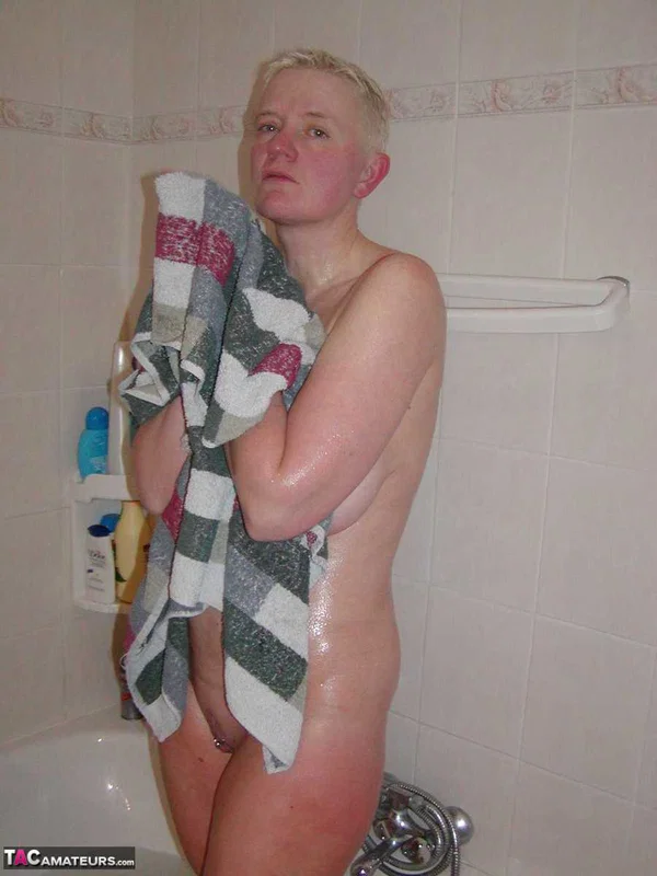 Older blonde woman Tiffany Pearl gets dressed after taking a bath  - Mature, Short Hair, Bath, Saggy Tits, Lingerie, Natural Tits, Leather, Big Tits, Tattoo, Panties  - Photo 1