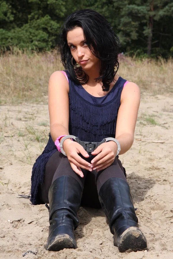 Brunette girl Nora is handcuffed to a tree while wearing a pink G-Shock watch  - Boots, Clothed, Beautiful, Outdoor, Leather, Skirt, Amateur, Solo, High Heels, Non Nude  - Photo 14