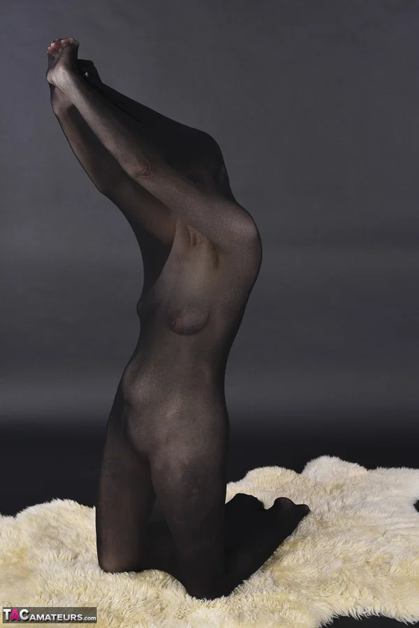 Naked mature woman encases herself in a stocking atop a rug  - Mature, Amateur, Saggy Tits, European  - Photo 6
