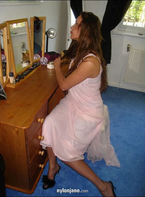 Older woman brushes her long hair in a mirror wearing nylons and garter belt  - Mature, Stockings, Panties, Clothed, Lingerie, Ass, Legs, High Heels, Big Tits, PAWG  - Photo 1