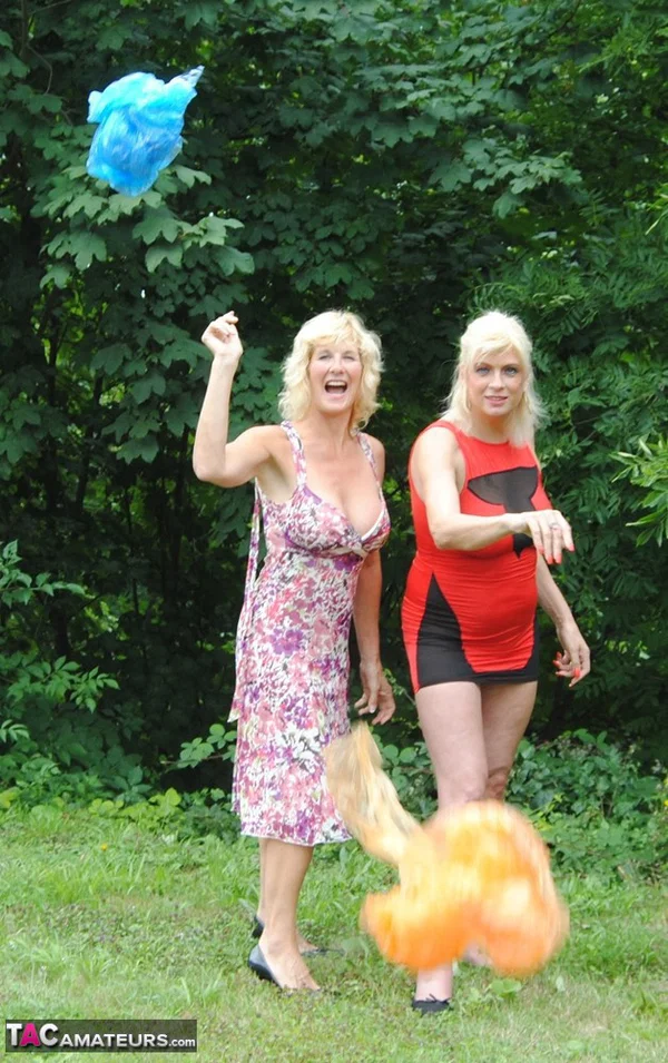 Mature lesbian Dimonty and GF cover their naked bodies in see thru raincoats  - Mature, Latex, Outdoor, Lesbian, Clothed, Skirt, Blonde, Humping, MILF, European  - Photo 12