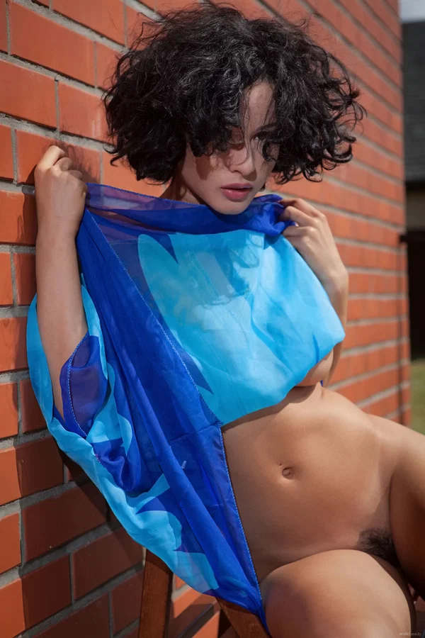 Naked teen with curly hair poses against a red brick wall for a solo shoot  - Curly, Perfect, Short Hair, Sexy, Petite, Legs, Pussy, Glamour, Teen, Model  - Photo 2