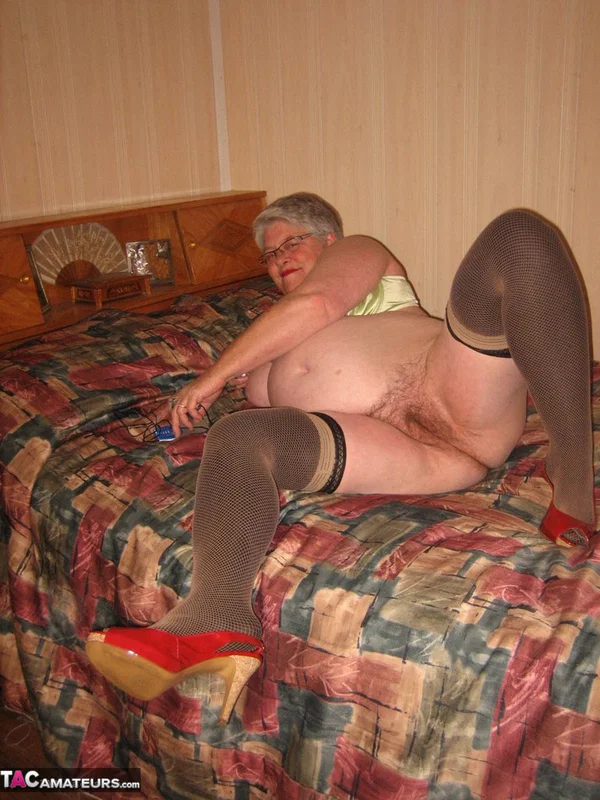 Fat granny Girdle Goddess pets her pussy after stripping to hosiery on her bed  - Granny, BBW, Stockings, Amateur, Glasses, High Heels, Clothed, Chubby, Short Hair, Curvy  - Photo 20