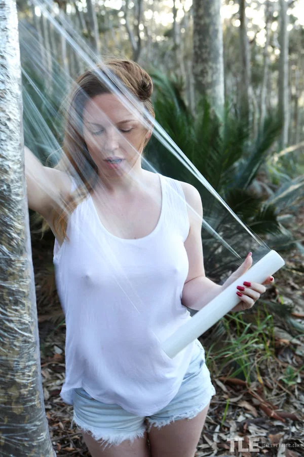Pale redhead Madison Missina restrained yourself to a tree with plastic wrap  - Pale, Fetish, Outdoor, Teen, Big Tits, Close Up, Shorts, Cute, Spreading, Babe  - Photo 2