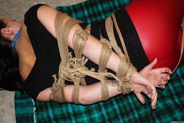 Clothed female lays on a blanket all tied up with ropes and ball gagged  - Bondage, Clothed, BDSM, High Heels, Babe, Schoolgirl, Brunette, Beautiful, Solo  - Photo 6